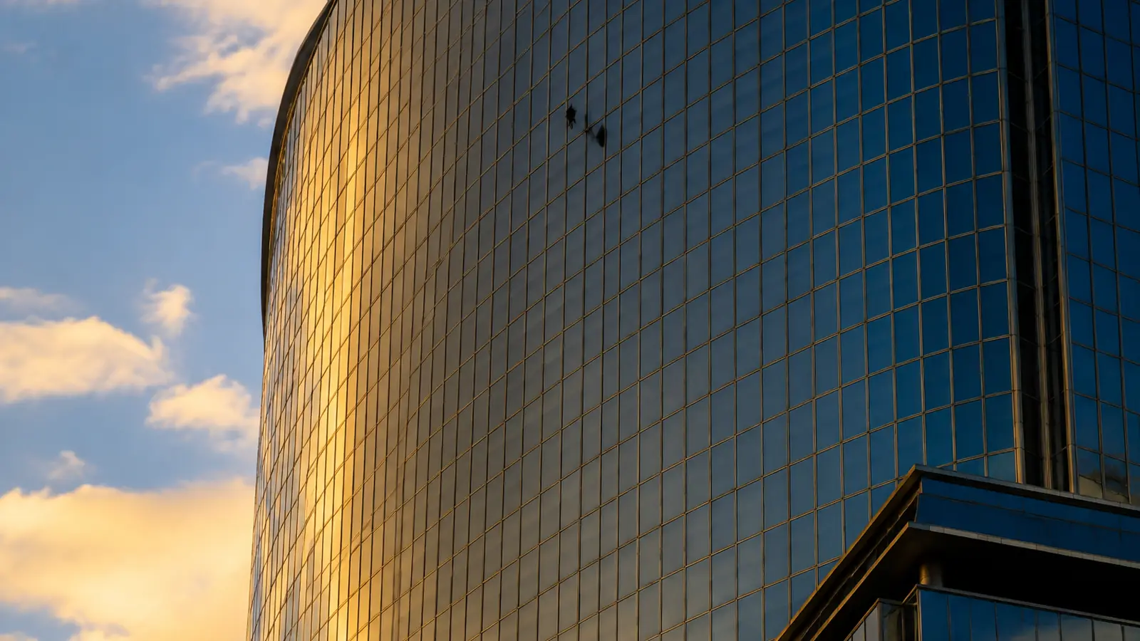 Technicians working the upper floors of a mid-rise glass building